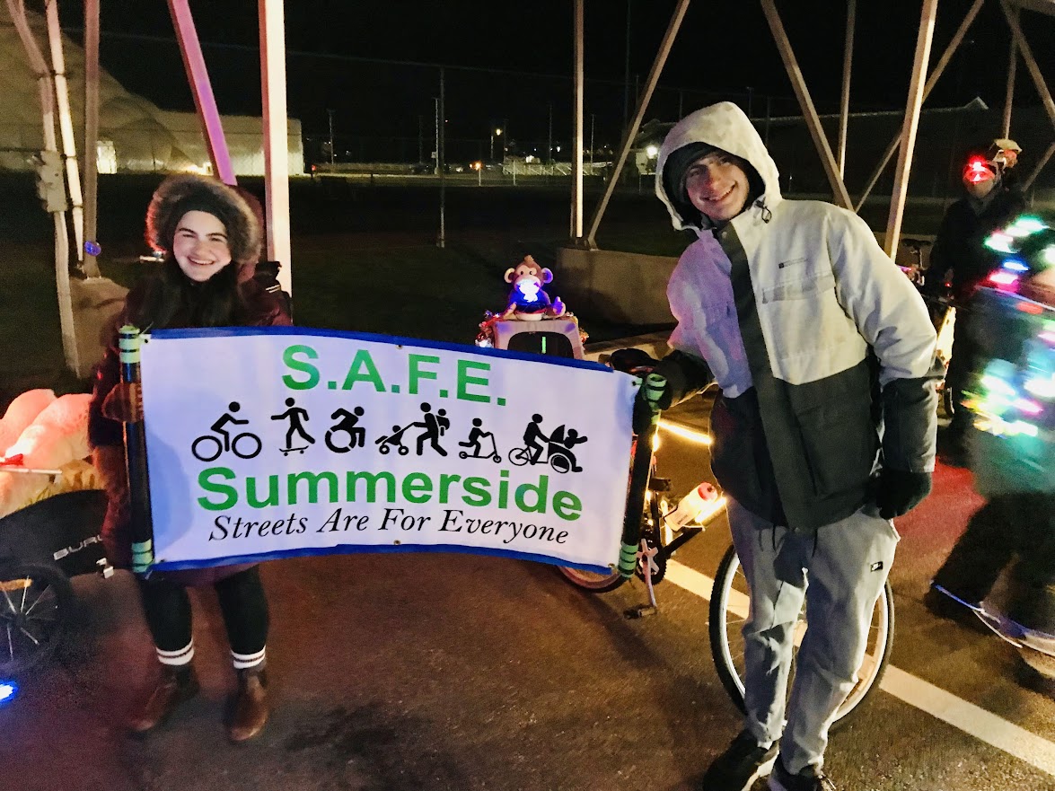 holding the SAFE Summerside banner at the parade