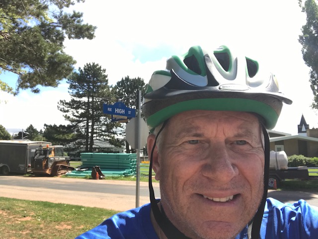 Bill Schurman cycling on Victoria and High Street in Summerside in 2022